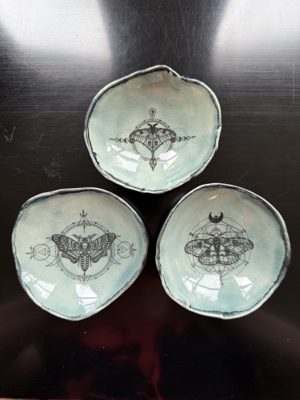 Set of three small dishes with moth illustrations